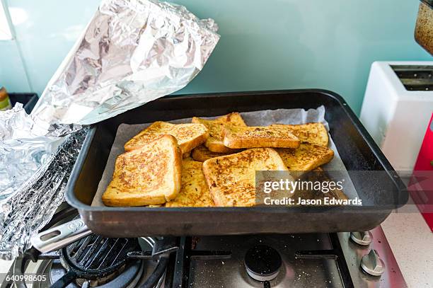 french toast in an oven warming tray waiting for christmas day breakfast. - pain perdu stockfoto's en -beelden