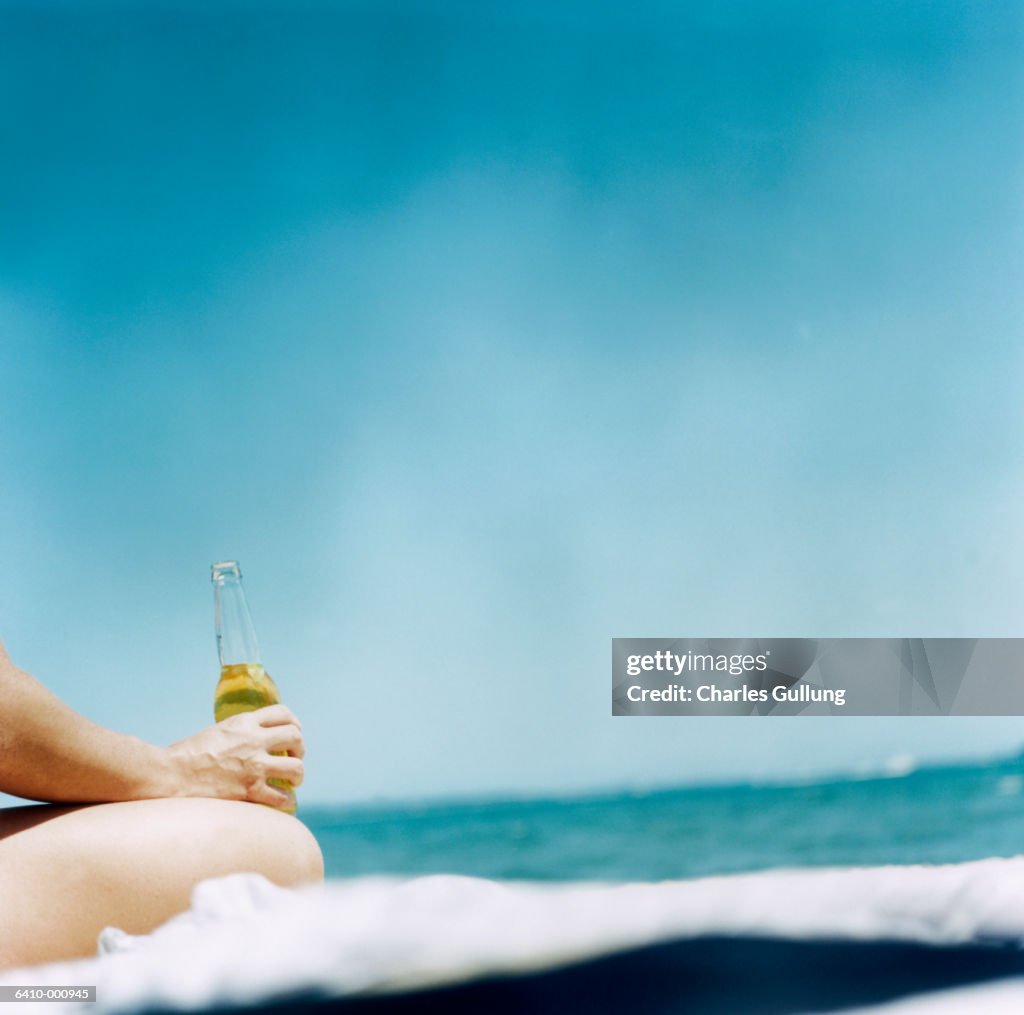 Person on Beach with Beer