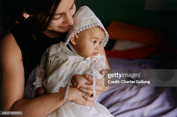 baby wearing christening gown - christening gown stock-fotos und bilder