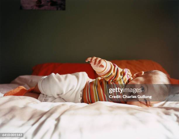 baby rolling over - baby rolling over stock pictures, royalty-free photos & images