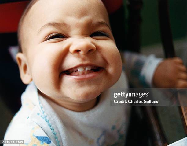 baby smiling - baby tooth stock-fotos und bilder