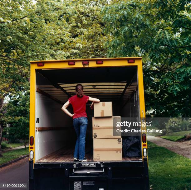 woman in back of moving van - removal men stockfoto's en -beelden