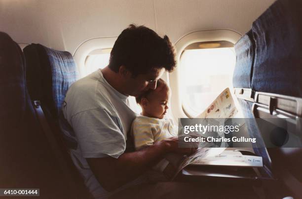 father and baby on airplane - flugzeug stock-fotos und bilder