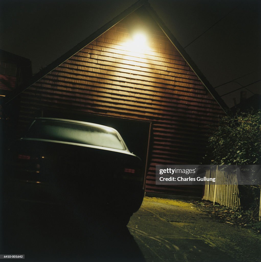 Car by Garage at Night