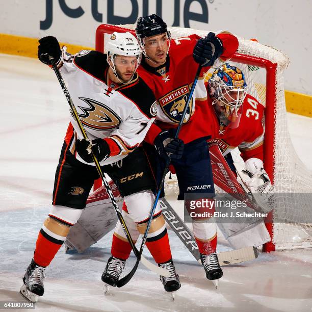 Goaltender James Reimer of the Florida Panthers defends the net with the help of teammate Colton Sceviour against Joseph Cramarossa of the Anaheim...