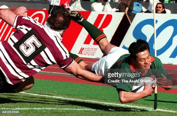 Keiji Hirose of Toyota Motor dives to score a try during the 35th All Japan Rugby Championship semi final match between Toyota Motor and Suntory at...