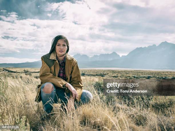 young woman in dramatic mountain landscape - environmentalist stock pictures, royalty-free photos & images
