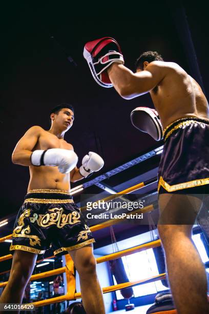 muay thai wedstrijd op boksring in thailand - asian indoor & martial arts games stockfoto's en -beelden