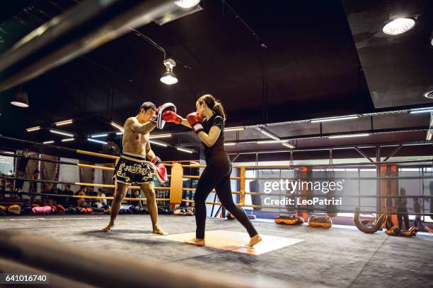 muay thai workout - motivational training at the gym facility - muaythai boxing stock pictures, royalty-free photos & images