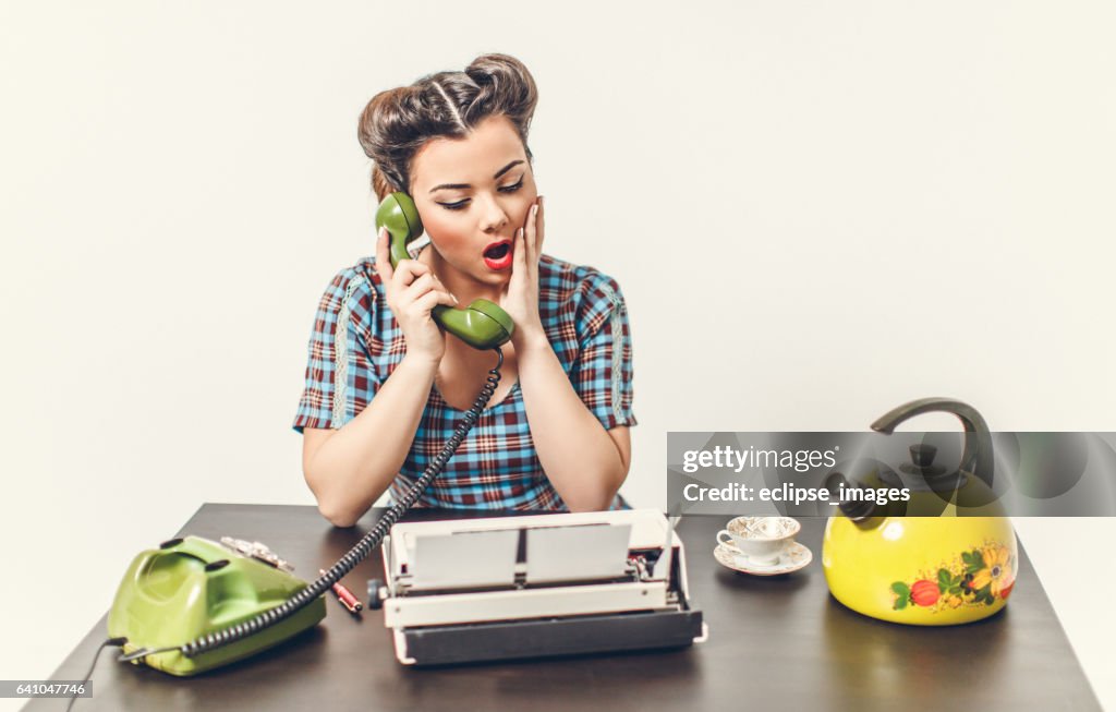 Retro styled woman using telephone