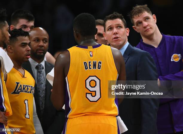 Timofey Mozgov looks on as Luke Walton talks with Luol Deng and D'Angelo Russell of the Los Angeles Lakers during a time out in the game against the...