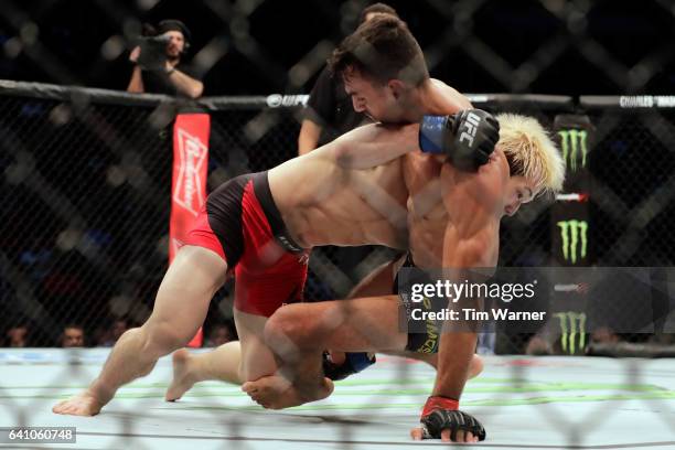 Ricardo Ramos battles Michinori Tanaka in the Bantamweight Bout during UFC Fight Night at the Toyota Center on February 4, 2017 in Houston, Texas.