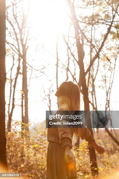 woman in the local park during susnet - leaning tree stock pictures, royalty-free photos & images