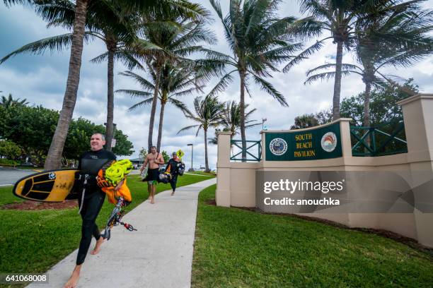 people walking from the beach before rain, boca raton, usa - boca raton stock pictures, royalty-free photos & images