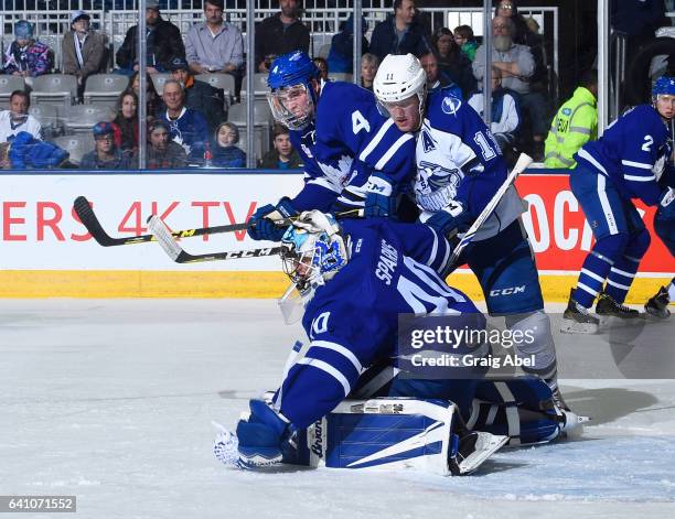 Garret Sparks of the Toronto Marlies stops a shot with help from team mate Justin Holl against Erik Condra of the Syracuse Crunch during AHL game...