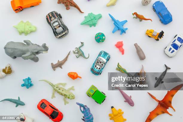 collection of plastic and rubber toys on a white surface.top view. - brinquedo imagens e fotografias de stock