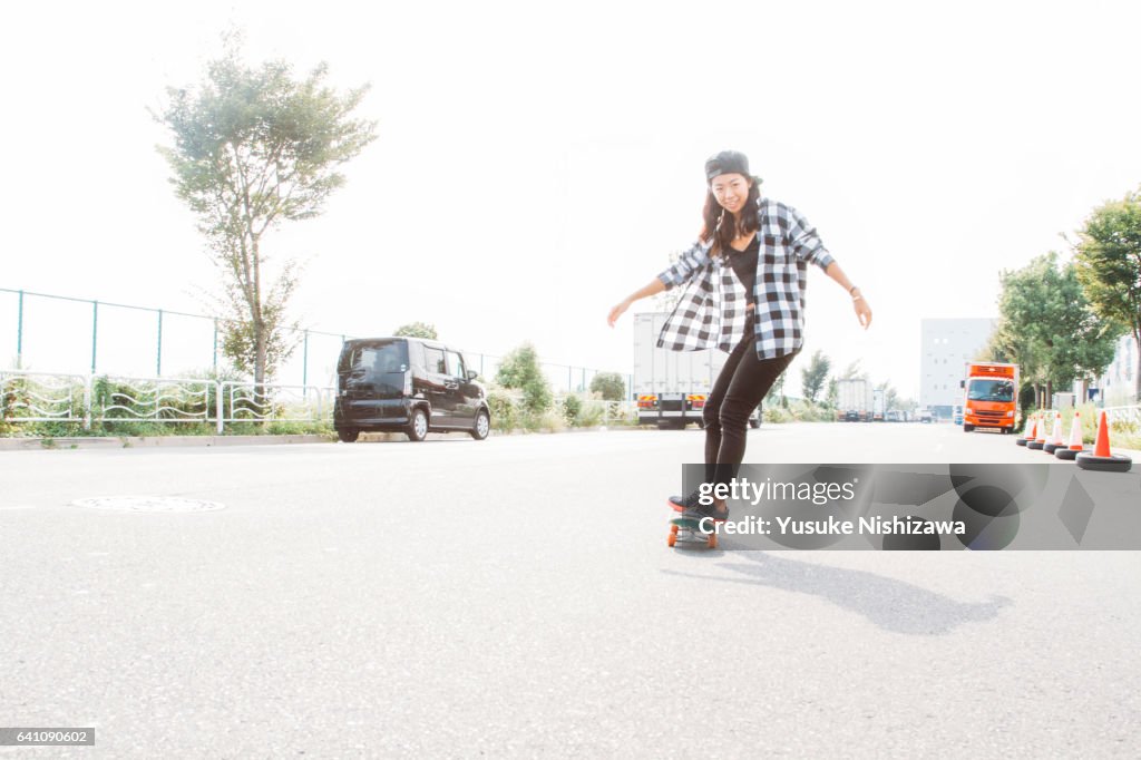 A girl playing a skateboard