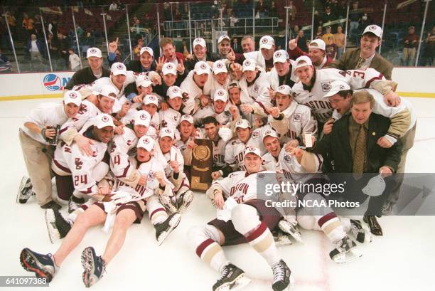Members of the National Champion Boston College team celebrate with the trophy after winning the Men's Division I Ice Hockey Championship held at...
