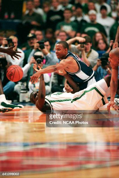 University of Arizona guard Jason Gardner and Michigan State center Zach Randolph battle for control of a loose ball during the Division I semifinal...