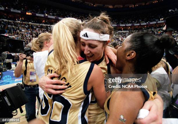 Ruth Riley hugs fellow senior teammates Kelley Siemon and Niele Ivey of Notre Dame after defeating Purdue during the Division 1 Women's Basketball...
