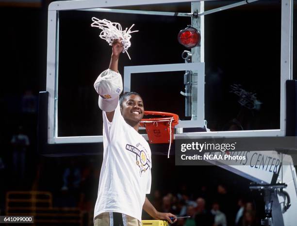 Guard Niele Ivey of Notre Dame cuts down the net after defeating Purdue during the Division 1 Women's Basketball Championships held at the Savvis...