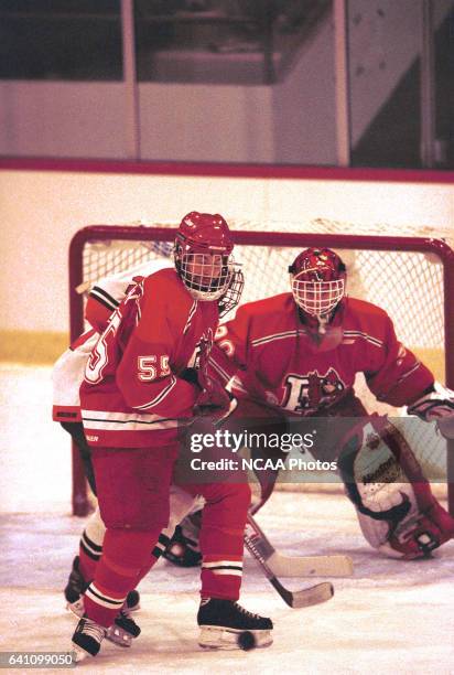 Bryan Murray of Plattsburg State University trys to clear the puck while goalie Niklas Sunberg minds the net during the 2001 NCAA Photos via Getty...