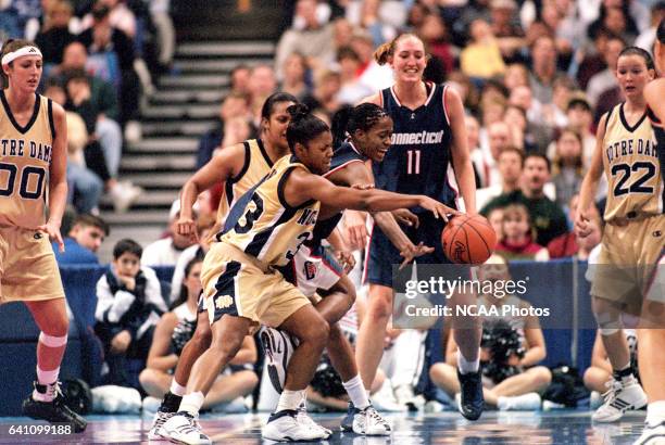 Guard Niele Ivey of Notre Dame battles forward Swin Cash of the University of Connecticut for a loose ball during the Division 1 Women's Basketball...