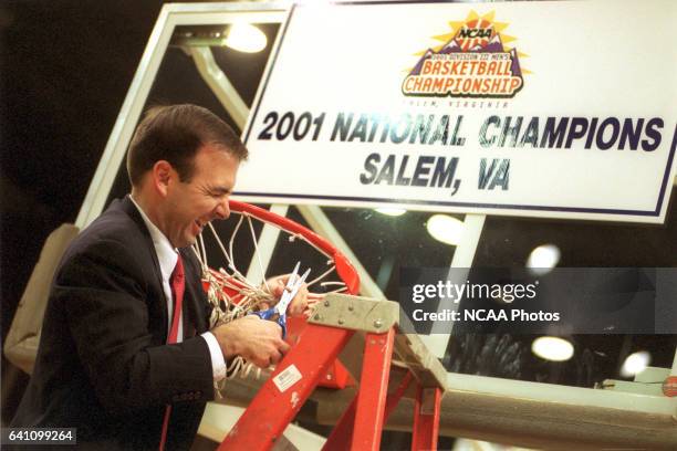 Head coach Mike Lonergan of Catholic University cuts down the net after the Men's Division III Basketball Championship held at the Salem Civic Center...