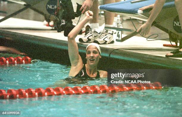 Kristy Kowal of Georgia raises an arm in victory after placing first and setting a new American record in the 200 yard breastroke during the 2000...