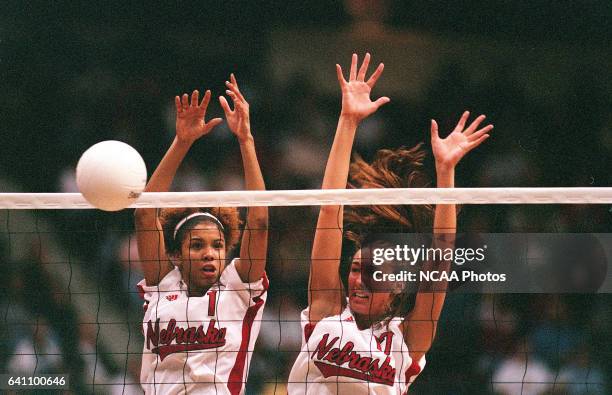 Setter Greichaly Cepero and middle blocker Jenny Kropp of Nebraska block a hit against Wisconsin during the Division 1 Women's Volleyball...