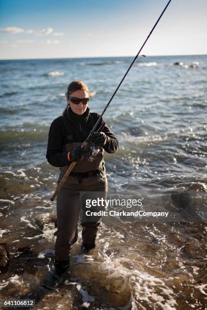 woman sea fishing at møns klint denmark - wading boots stock pictures, royalty-free photos & images
