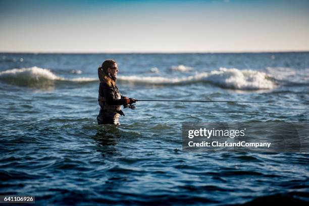 woman sea fishing at møns klint denmark - surf casting stock pictures, royalty-free photos & images