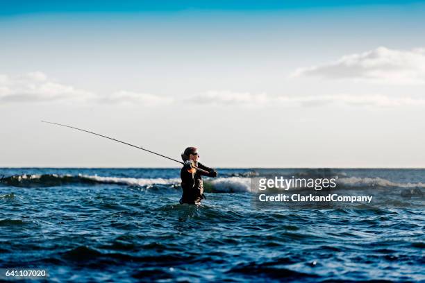woman sea fishing at møns klint denmark - surf casting stock pictures, royalty-free photos & images