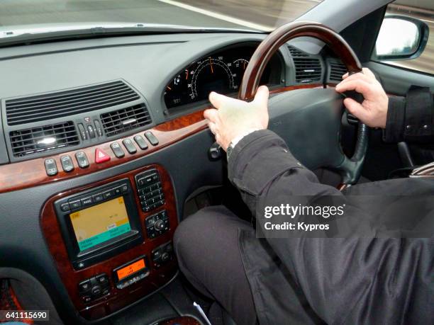 europe, uk, england, london, view of hand of male driver holding car steering wheel - car stereo stock pictures, royalty-free photos & images