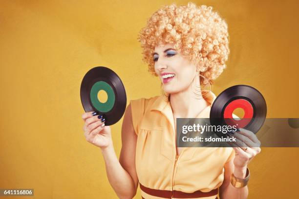 70's retro woman holding records - numismatics stock pictures, royalty-free photos & images