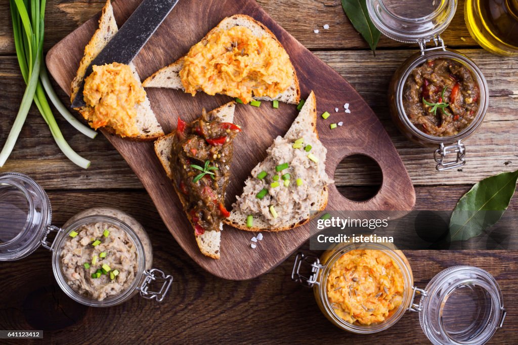 Set of different homemade vegetable and bean pastes, sandwiches with vegan pate