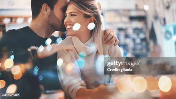 couple on a romantic date at a coffee house. - happy couple flirt stock pictures, royalty-free photos & images