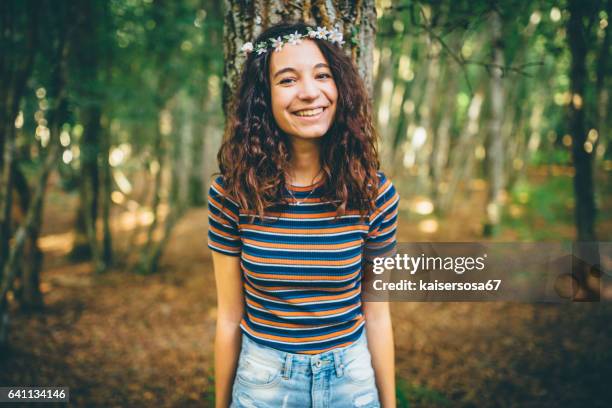 girl with floral crown enjoying nature in the forest - flower crown stock pictures, royalty-free photos & images