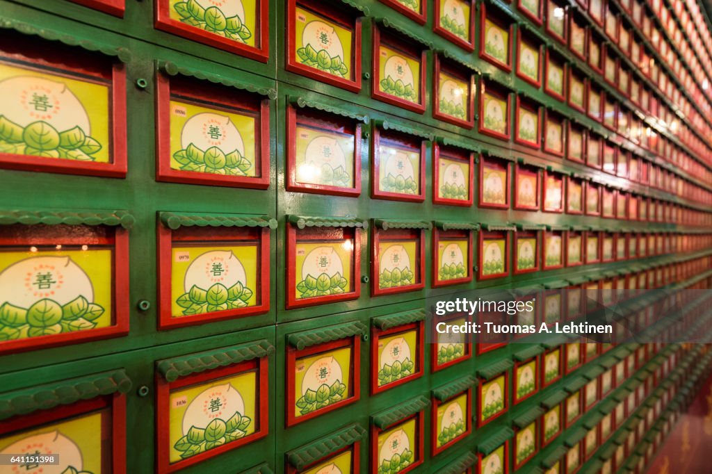 Close-up of a wall full of drawers that contain ashes of the deceased inside the Man Mo Temple in Sheung Wan on the Hong Kong Island in Hong Kong, China.