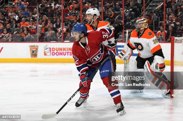 Brian Flynn of the Montreal Canadiens battles against Nick Schultz alongside goaltender Michal Neuvirth of the Philadelphia Flyers on February 2,...