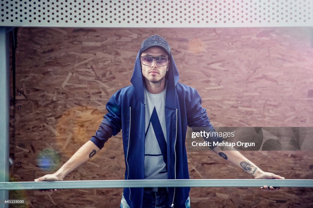 Portrait of cool young man, in urban street