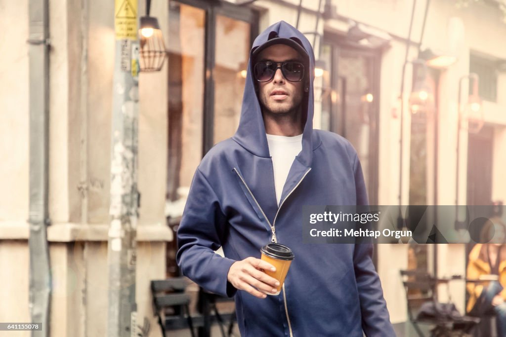 Cool young man standing in urban street