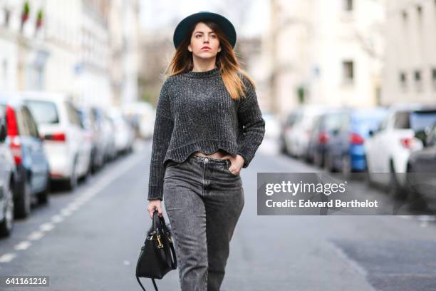 Sara Carnicella, fashion blogger from La Fille Rebelle, wears Texto black shoes, a Zara gray wool pull over, Calzedonia fishnet tights, Zara gray...