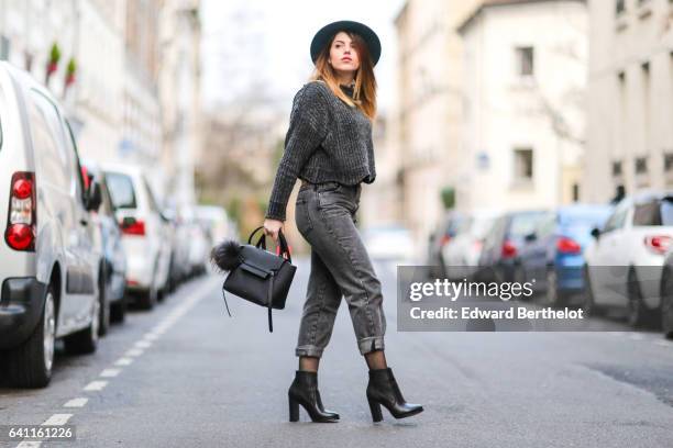 Sara Carnicella, fashion blogger from La Fille Rebelle, wears Texto black shoes, a Zara gray wool pull over, Calzedonia fishnet tights, Zara gray...