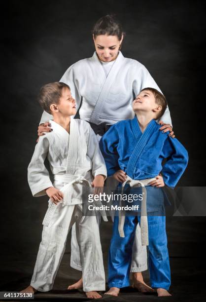female judo fighter with little disciples - judo female stock pictures, royalty-free photos & images