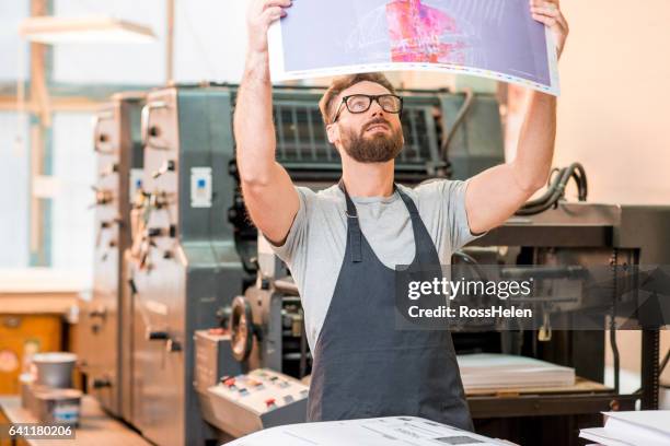 man at the old printing plant - t shirt printing stock pictures, royalty-free photos & images