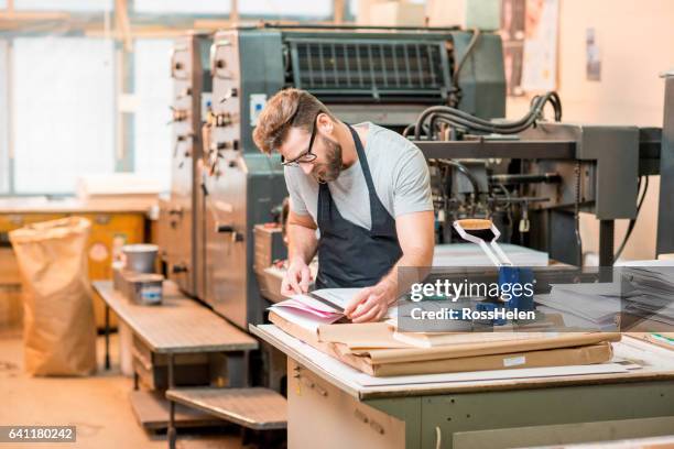 man at the old printing plant - t shirt printing stock pictures, royalty-free photos & images