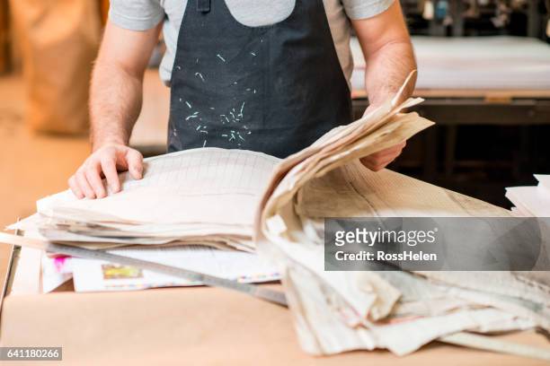 man at the old printing plant - t shirt printing stock pictures, royalty-free photos & images