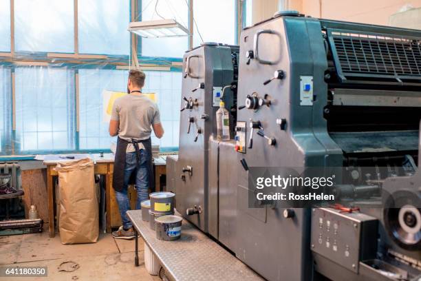 man at the old printing plant - schürze mann rückansicht stock-fotos und bilder