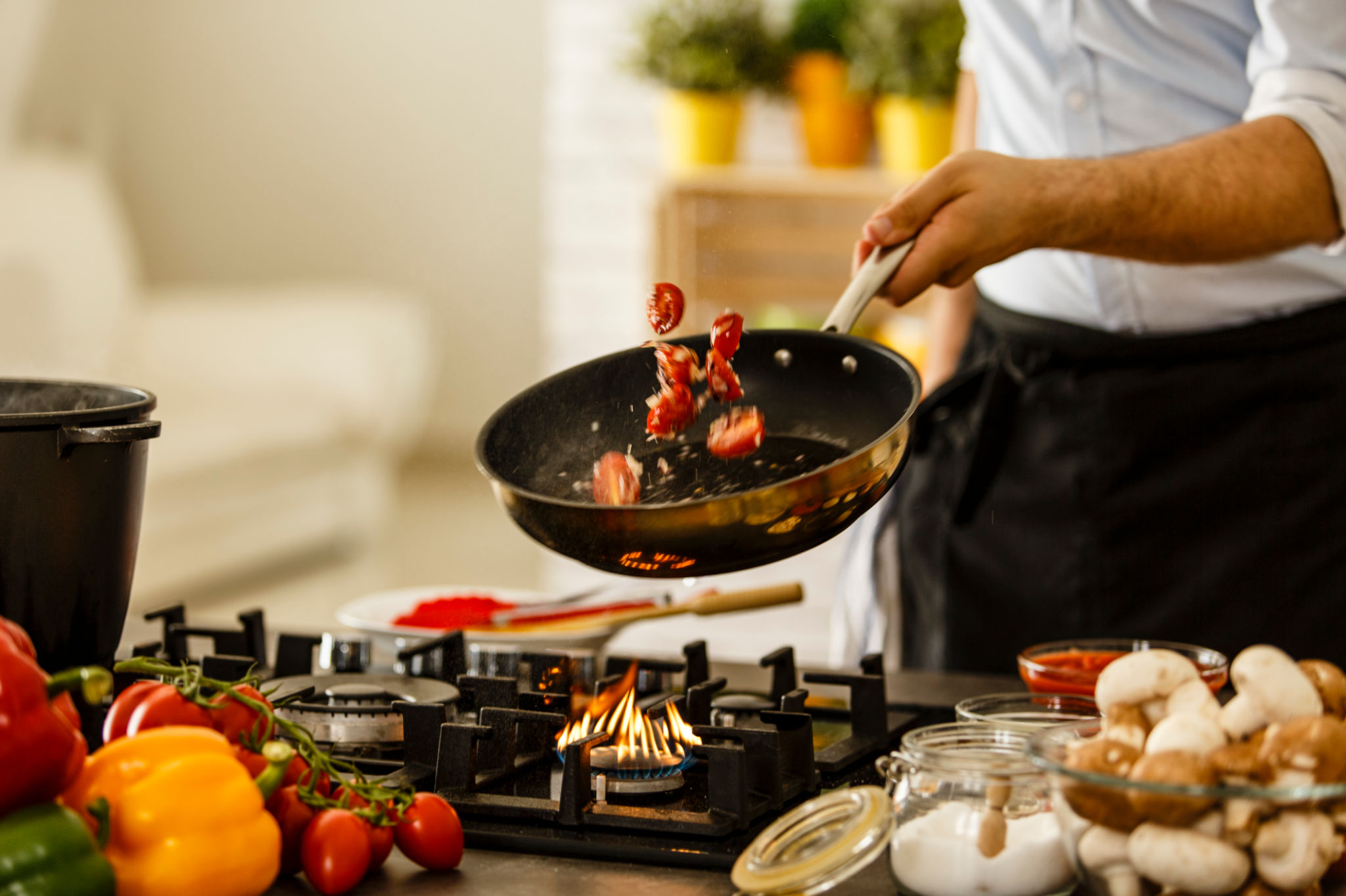 Chef tossing vegetables from cooking pan. cooking at home Chef tossing vegetables from cooking pan. cooking at home